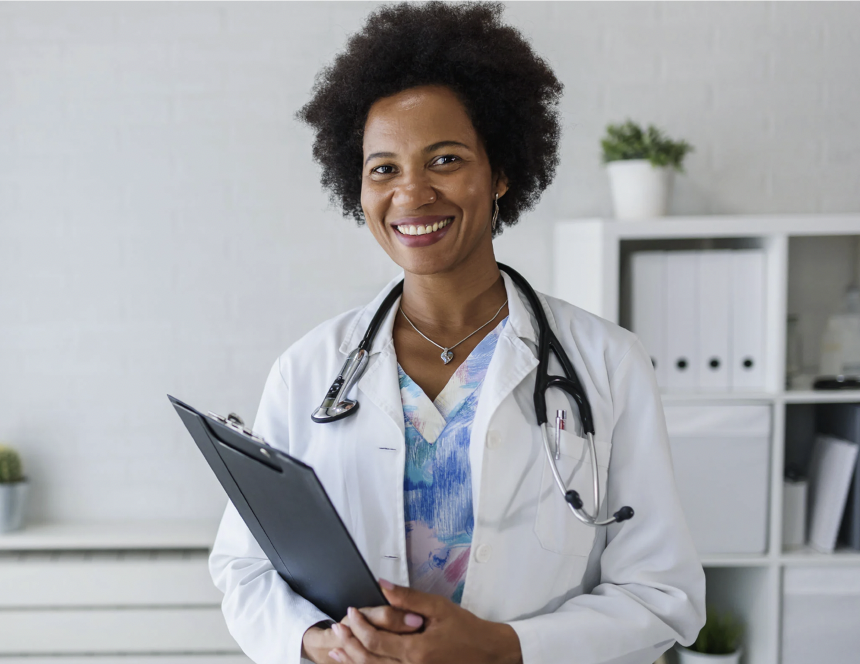 a black female medical professional holding a clipboard and smiling