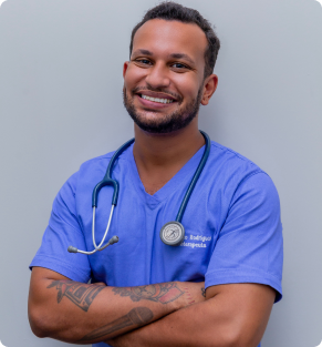 male medical professional smiling with arms crossed