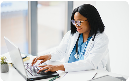 Nurse practitioner Smiling at Computer