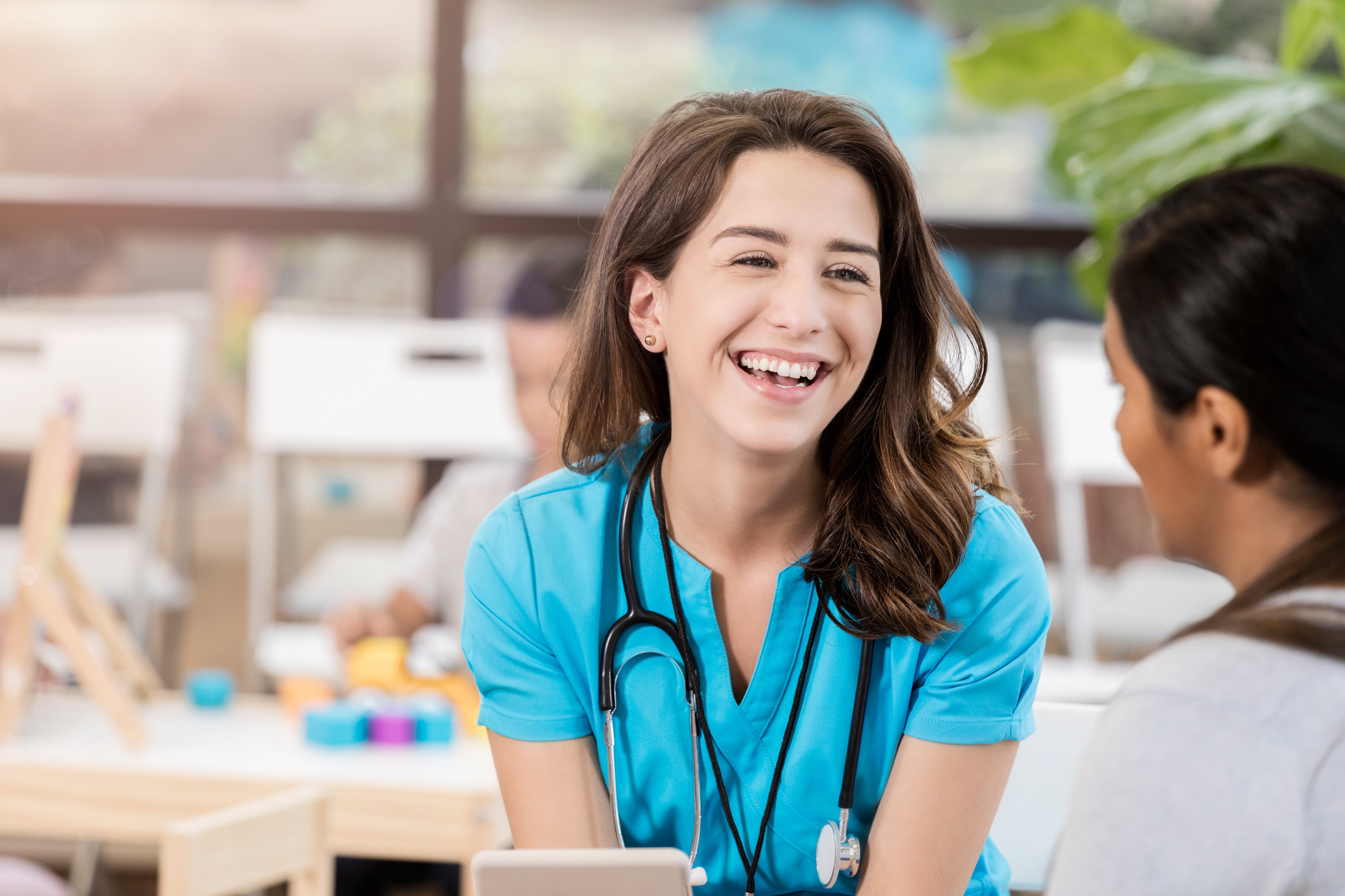 female medical professional smiling at another person