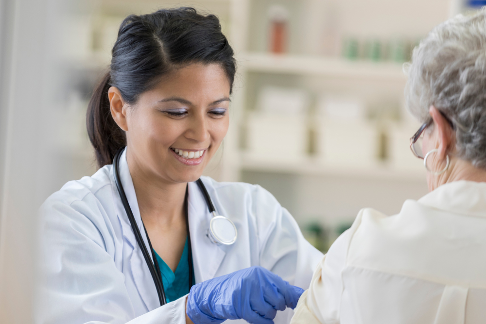 a female medical professional providing care to an elderly patient